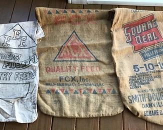 Several old feed sacks cloth and burlap