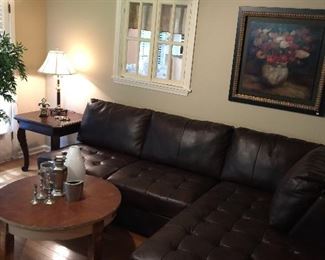 Faux leather sectional, round coffee table