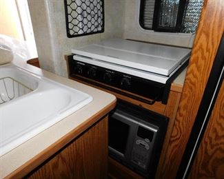 Microwave and stove area. This is a galley kitchen, keep in mind the second slide out is in the "closed" position.