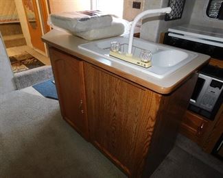 Galley kitchen with double sink.