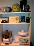Top row: Industrial/Marine Cage Lantern, Vases, Boston Rotary Pencil Sharpener. Middle row: Dexter Mat Cutter, Vintage DeWald Radio (Bakelite case), Aiwa cassette player, Crown 6 Transistor radio. Bottom Row: Acme JuicERactor #6001, Acme Citrus Extractor attachment, Villa Ware Pasta Maker.