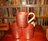Five (5) MOSCOW MULE / SMIRNOFF MULE MUGS
Aluminum mugs - copper color. Artist has wrapped the handle of these mugs in leather. The leather can be removed.
