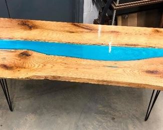 This beautiful, award-winning table was handcrafted from tree to final product. The wood was taken from the craftsman neighbor's red oak tree and was saved until it became this lovely piece of handmade table. It measures 84" long, 33" wide, 29.5"tall. The live edge, of course, means the width fluctuates a bit. The "river" is made with blue-dyed epoxy. 
