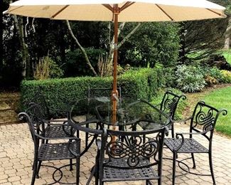 Nine piece patio set has oval 6' table, six arm chairs, umbrella & stand