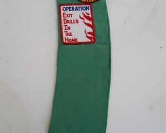 Girl Scout sash with badges, pins.