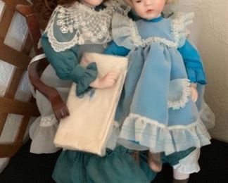 2 Porcelain Dolls On Chair