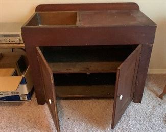 Wash cabinet with copper basin.