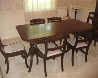 Small mahogany dining table with 1 leaf, table pads and 8 chairs