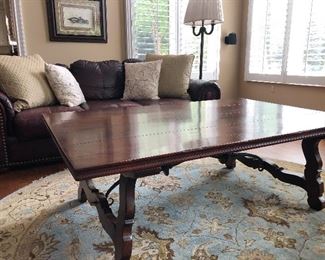 Coffee Table, leather couch, floor lamp and round area rug