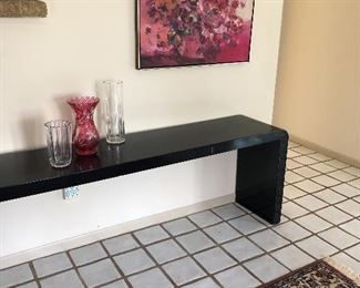 long black lacquer table, framed acrylic and crystal vases