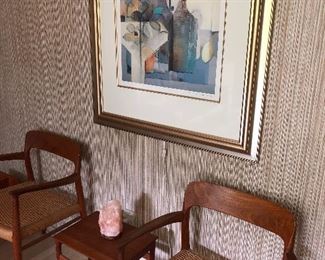 Teak chairs and side table, along with framed watercolor