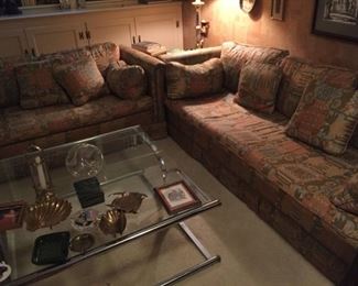 Assorted accessories, glass coffee table and matching sofas.