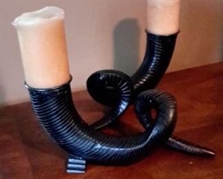 Two heavy metal horn candle holders.