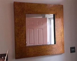 Large mirror with gold speckled frame.