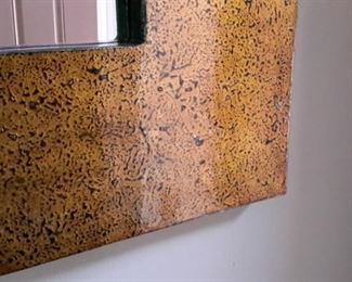 Large mirror with gold speckled frame.