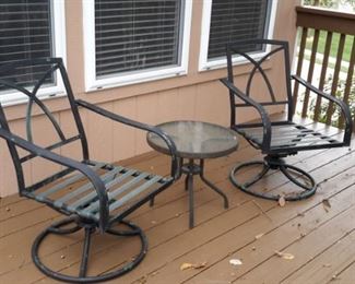 Two swivel/rocking patio chairs and one glass top side table.