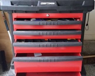 Craftsman tool chest with casters, peg boards on the side and added ceramic tile on top.