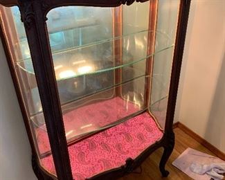 Has 2 glass shelves and lights up. This makes a statement in any room!
