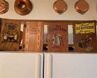 A huge collection of vintage cookbooks. These have wood covers.