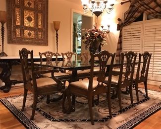 Glass top dining table with 6 side chairs and 2 arm chairs with leather upholstered seats 