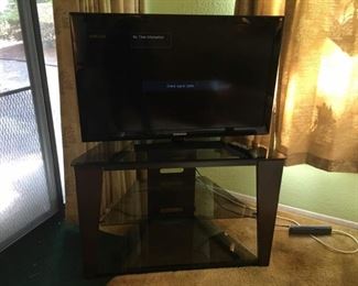 Samsung 40" TV Model# LN40E550F7F, Corner Tempered Glass & Metal TV Shelf.
Lot Number: 11