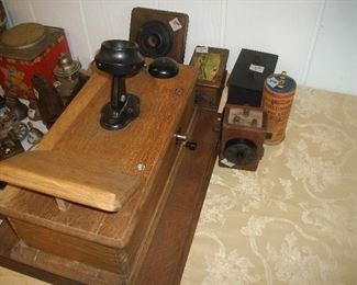Antique wall phone with misc accessories.  There is a "loud speaker" and some battery somethings.