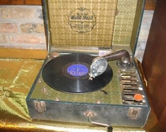 Portable "Victrola" with extra needles.  This could probably use a bit of a tune-up.   It winds up but almost seems that the "arm" is too heavy.  You'll probably know what to do if this is something you'd be interested in.
