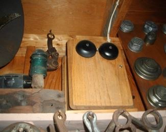 Antique telephone and some antique hub "caps".  There are more "metal" things in this picture too.  Don't know what they are.