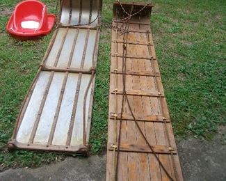 Two antique toboggans.  One is 80+ inches long and the other is 70+.  Really nice!  Also a "baby" sled