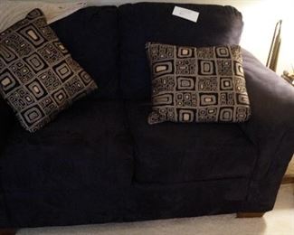 black love seat with pillows