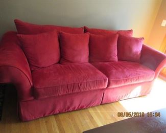 red sofa has matching overside chair and ottoman