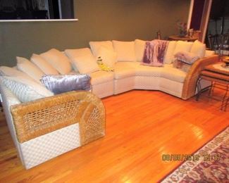 curved sectional upholstered with wicker side arms, it is beautiful