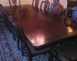 Glorious solid mahogany dining room table with 10 chairs in MINT condition--also notice the room size hand knotted rug