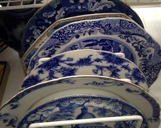 Assorted shapes and sizes of transferware plates
