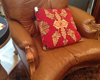 Brown leather chair; decorative pillow