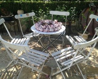 White folding chairs; small round table (sold separately)