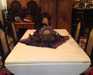 This drop-leaf table has 3 more leaves. It can easily seat 12 people.