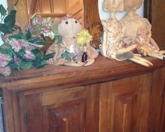 Large storage chest; framed mirror; vintage dolls