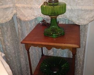 Small side table; green glass hurricane lamp