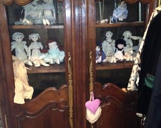 Display armoire filled with rag dolls