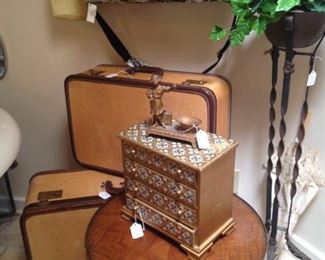 Plant stand; vintage luggage; lace umbrella; jewelry box