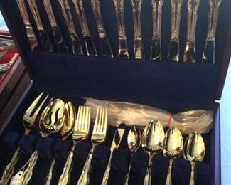 International gold plate dinnerware in chest