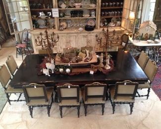 There are twelve impressive dining chairs with brass handles atop each back; it is rare to find 12 matching chairs.