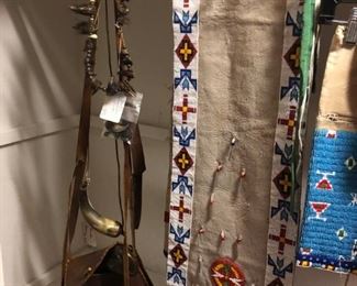 Bear claw necklace, antique powder horns and hunting pouches, and an incredible beaded sash.