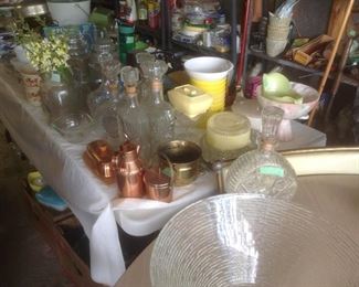 Tables full of metal , glass, and other household items