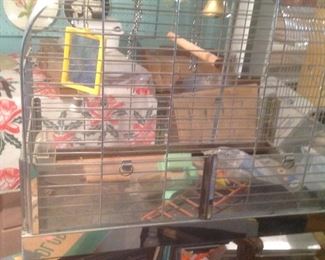 Birdcage on a stand with many items within cage.....presale at $100