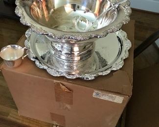 Wonderful 40 year old punch bowl with under tray, 12 cups and ladle.  Never been out of the box!