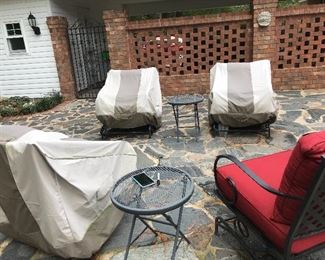 More patio furniture with cushions and covers.