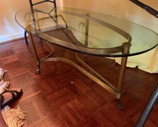 #32 glass top oval coffee table w brass base as is 55x26x16 $25.00