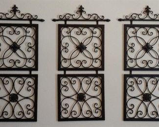 Decorative wrought iron wall hangings featured in many sizes and shapes hang throughout the home.
